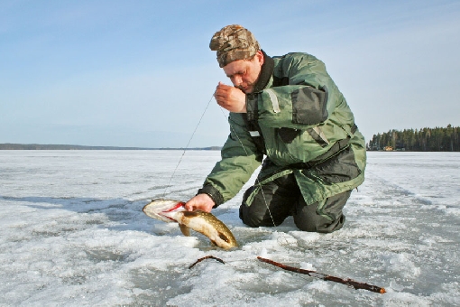 Im Winter werden Hechthaken an den Rändern von Untiefen nur wenige Meter unter der Eisschicht ausgeworfen. Der See Toisvesi, Virrat.