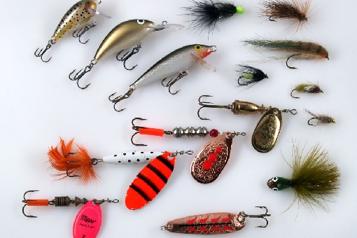 Ide lures. Plugs from left to right: Rapala Mini Fat Rap, Salmo Hornet and Rapala CountDown. Spinners from left to right: Mepps Aglia, Abu Reflex, Paavo-lippa and Vibrax. In the right: different kind of flies for ide and MA Mutu-Leech (undermost). Down below in the middle: Salamander.